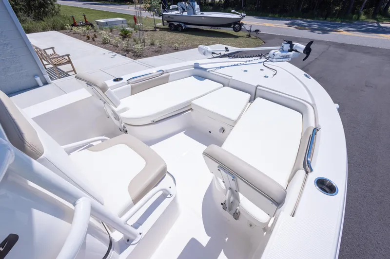 Slide: The Image of 2023 Robalo 206 Cayman boat interior with white seating and modern design. - 19