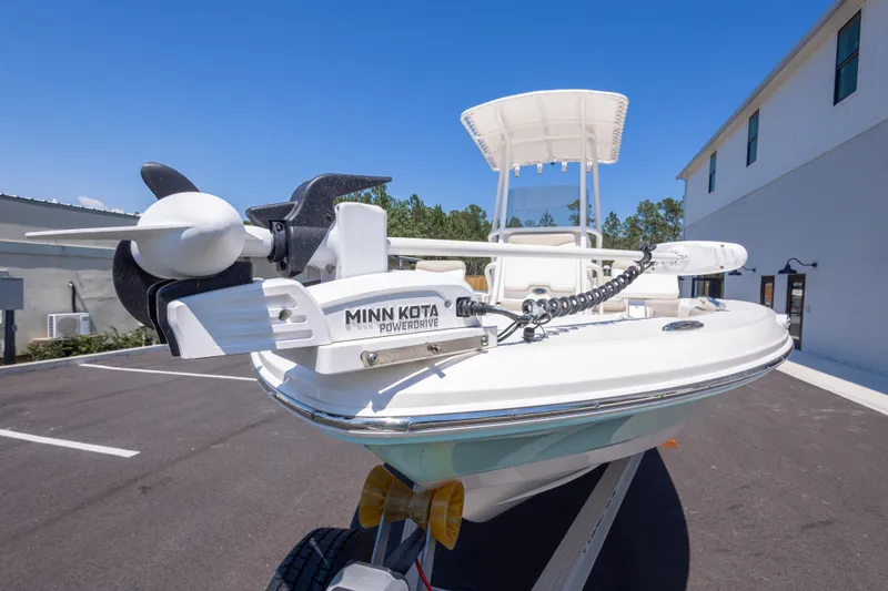 Slide: The Image of 2023 Robalo 206 Cayman boat with Minn Kota PowerDrive motor in a parking lot. - 8