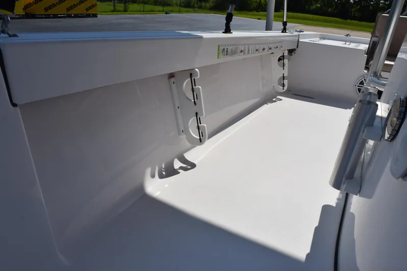 Slide: The Image of 2019 Sportsman Masters 207 Bay Boat interior, showcasing clean deck and rod holders. - 11