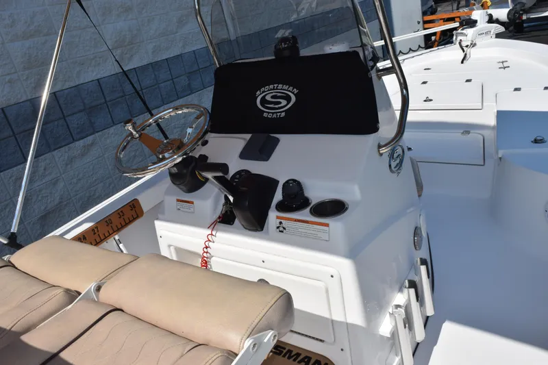 Slide: The Image of 2019 Sportsman Masters 207 Bay Boat cockpit with steering wheel and control panel. - 5