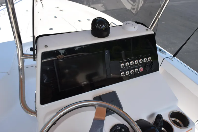 Slide: The Image of 2019 Sportsman Masters 207 Bay Boat dashboard with navigation controls and steering wheel. - 22