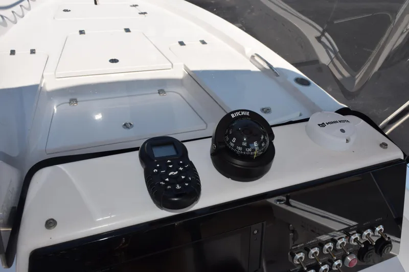 Slide: The Image of 2019 Sportsman Masters 207 Bay Boat dashboard with compass and control panel. - 23
