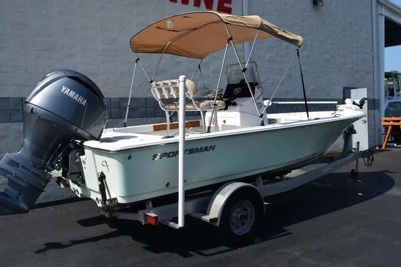 Slide: The Image of 2019 Sportsman Masters 207 Bay Boat with Yamaha engine on trailer, parked outdoors. - 4