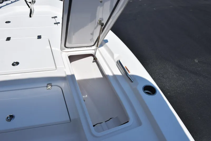 Slide: The Image of 2019 Sportsman Masters 207 Bay Boat storage compartment open on deck. - 14