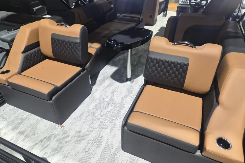 Slide: The Image of Luxurious interior seating of 2026 Sylvan L3 SLZ boat with tan and black upholstery. - 25