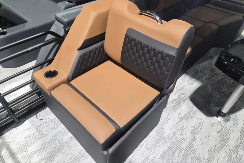 Slide: The Image of 2026 Sylvan L3 SLZ boat seat with tan and black upholstery, featuring a cup holder. - 23
