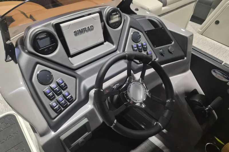 Slide: The Image of 2026 Sylvan L3 SLZ boat dashboard with steering wheel and Simrad navigation system. - 14