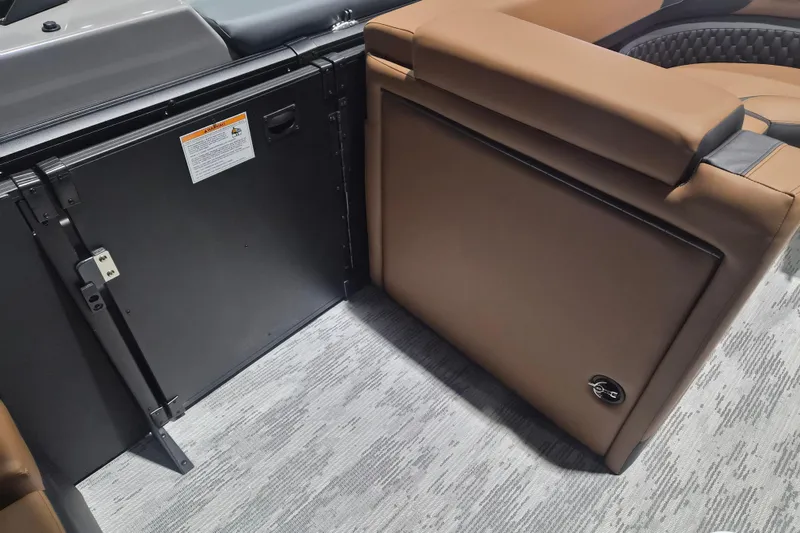 Slide: The Image of Interior of 2026 Sylvan L3 SLZ boat with brown seating and storage compartment. - 11