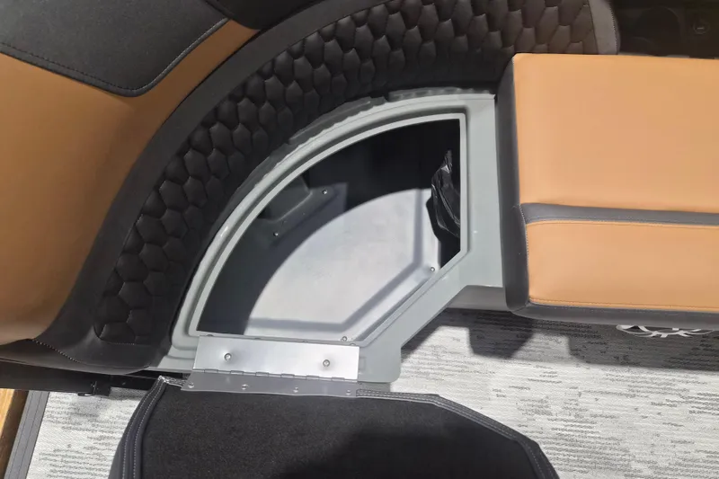 Slide: The Image of Interior storage compartment of 2026 Sylvan L3 SLZ boat with brown seating. - 4