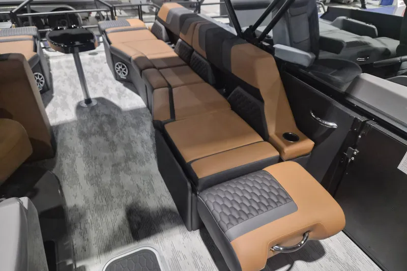 Slide: The Image of 2026 Sylvan L3 SLZ boat interior with luxurious brown and black seating arrangement. - 9