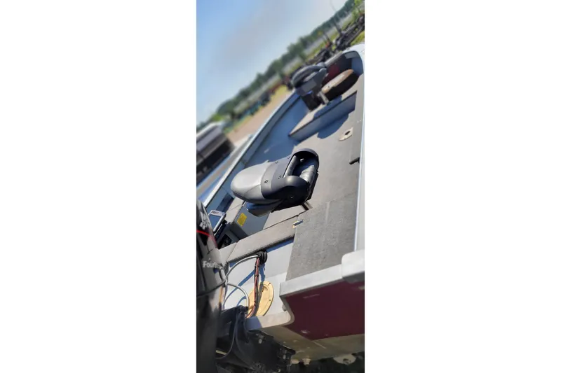 Slide: The Image of 1989 Lund 1600 Stinger boat interior with seating and equipment, outdoors on a sunny day. - 6