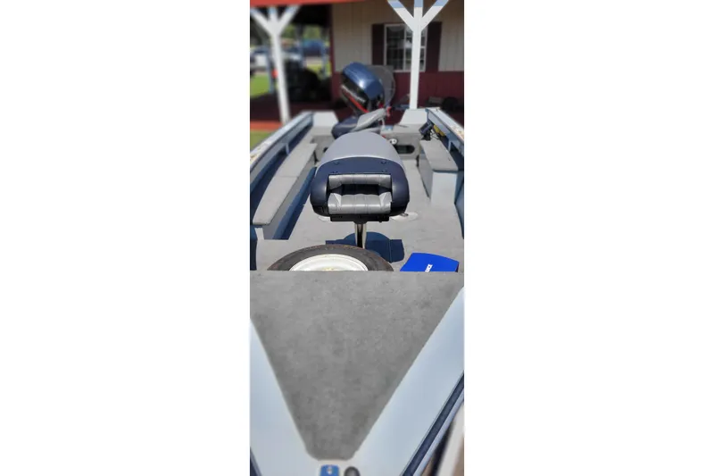 Slide: The Image of 1989 Lund 1600 Stinger boat interior with seating and motor, showcasing fishing setup. - 4
