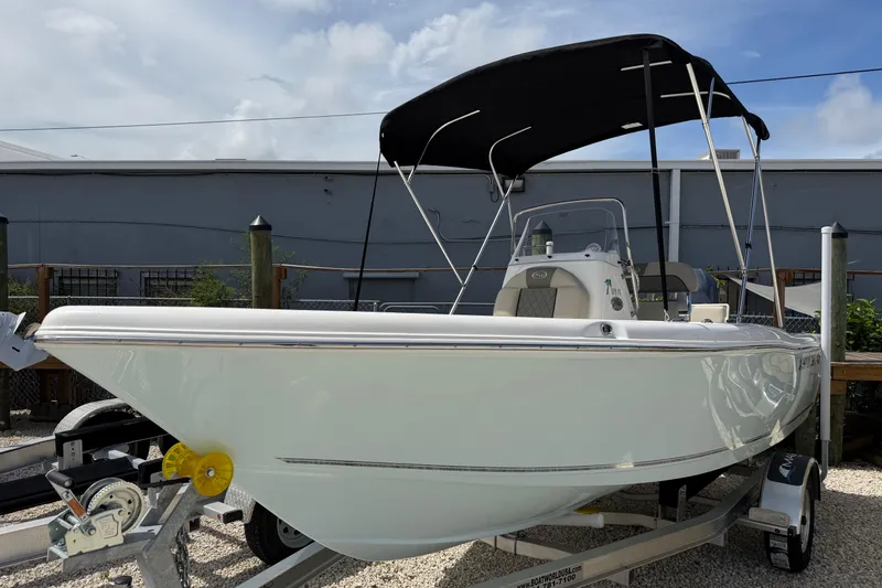 Slide: The Image of 2026 Key West 179 FS boat with canopy on trailer, parked outdoors. - 4