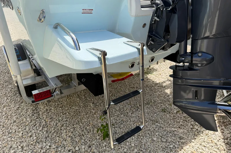 Slide: The Image of Rear view of 2026 Key West 179 FS boat with ladder and motor. - 7