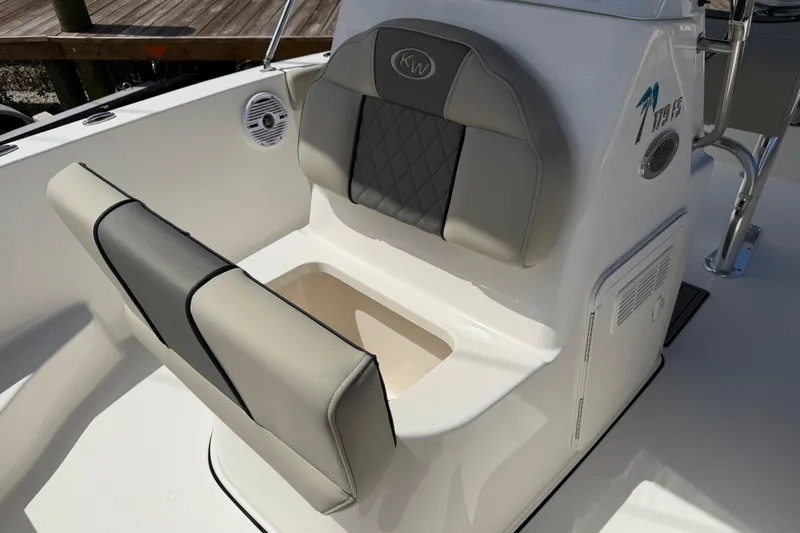 Slide: The Image of 2026 Key West 179 FS boat seat with storage compartment, featuring gray and white upholstery. - 24