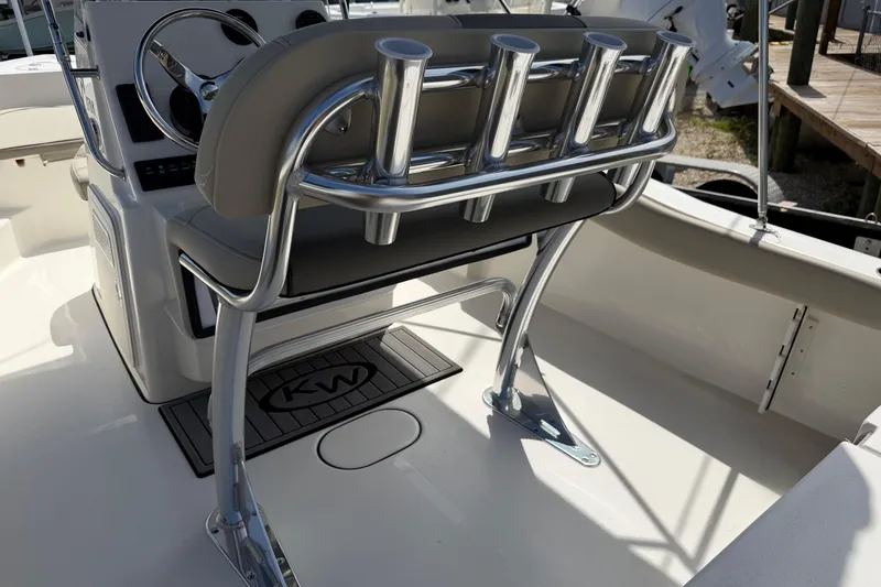 Slide: The Image of 2026 Key West 179 FS boat interior with steering wheel and rod holders. - 13