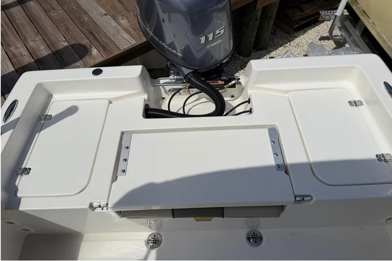 Slide: The Image of 2026 Key West 179 FS boat with Yamaha 115 engine, featuring rear storage compartments. - 11