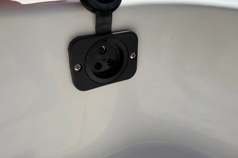 Slide: The Image of Close-up of a 2026 Key West 179 FS boat's electrical socket on a white surface. - 22