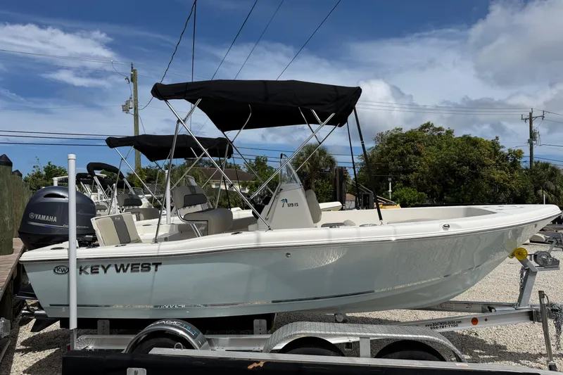 The Image of 2026 Key West 179 FS boat with Yamaha engine on a trailer, under a clear sky. - 1