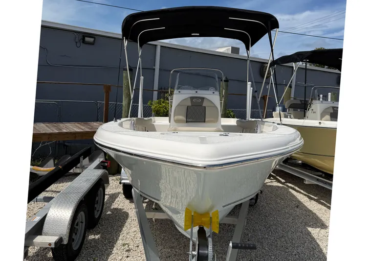 Slide: The Image of 2026 Key West 179 FS boat with canopy on trailer, parked outdoors. - 3