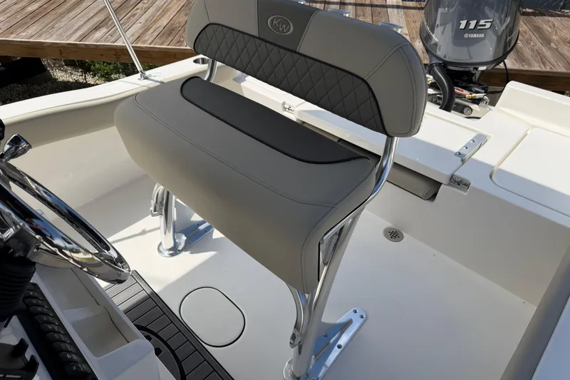 Slide: The Image of 2026 Key West 179 FS boat interior with steering wheel and seating. - 14