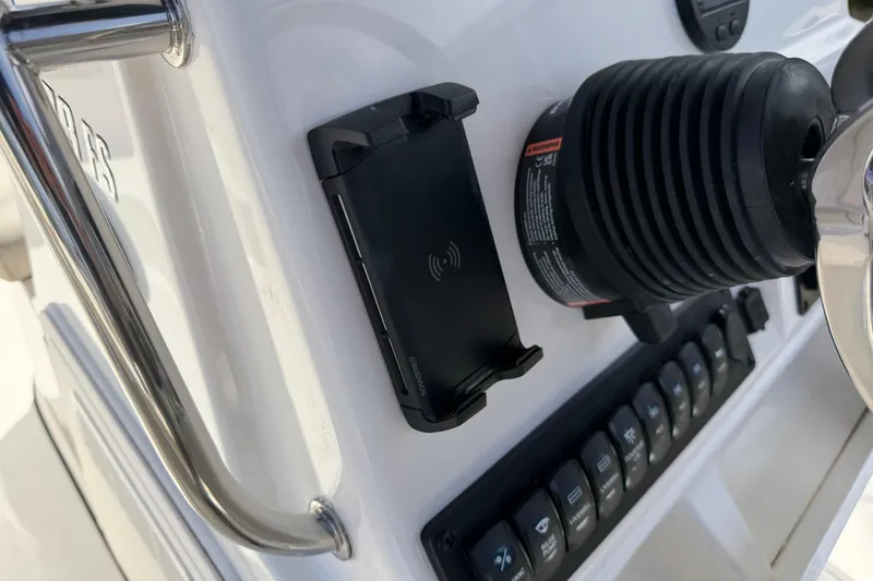 Slide: The Image of Control panel of 2026 Key West 179 FS boat with switches and steering wheel. - 17