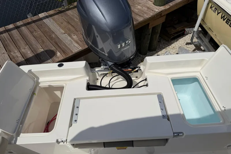 Slide: The Image of 2026 Key West 179 FS boat with Yamaha 115 engine, featuring storage compartments. - 12