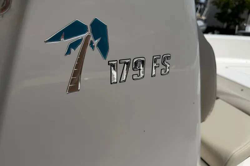Slide: The Image of 2026 Key West 179 FS boat logo with palm tree design on white surface. - 26