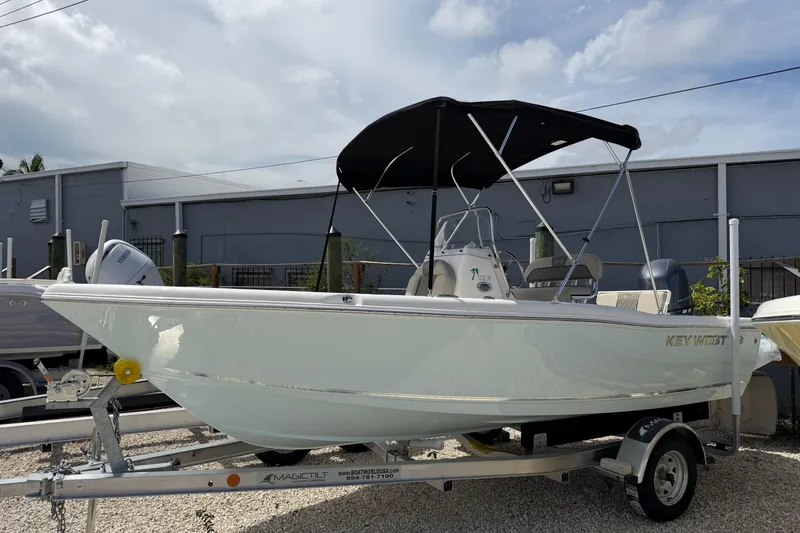 Slide: The Image of 2026 Key West 179 FS boat on trailer with black canopy, parked outdoors. - 5