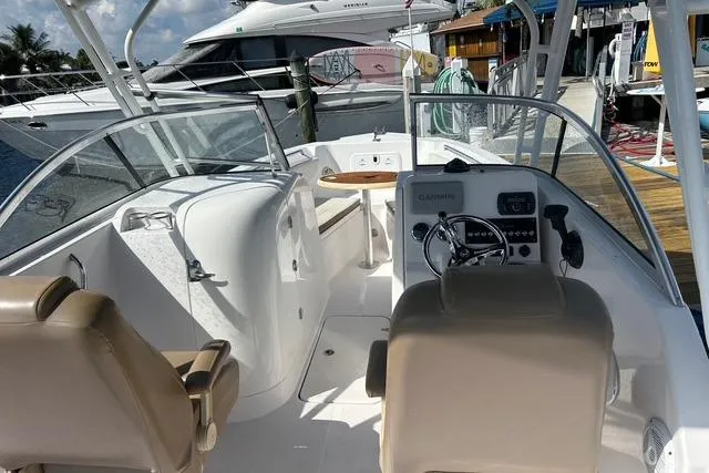 Slide: The Image of 2018 Pro-Line 23 Dual Console boat interior with steering wheel and seating. - 4