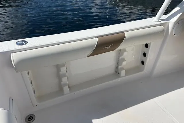 Slide: The Image of 2018 Pro-Line 23 Dual Console boat interior with white seating and storage compartment. - 23