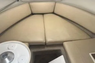 Slide: The Image of 2008 Maxum 2100 SC3 boat interior with beige seating and a small table. - 10
