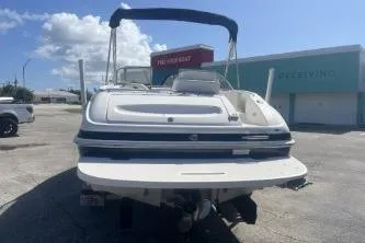 Slide: The Image of 2008 Maxum 2100 SC3 boat, rear view, parked outdoors under a clear sky. - 6