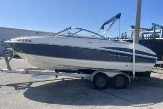 Slide: The Image of 2008 Maxum 2100 SC3 boat on trailer, parked outdoors under clear sky. - 5