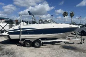 The Image of 2008 Maxum 2100 SC3 boat on trailer, parked outdoors under a cloudy sky. - 1