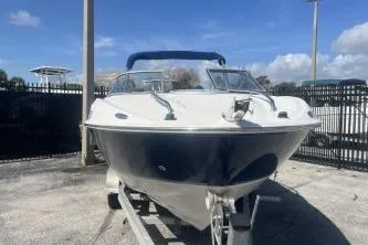 Slide: The Image of 2008 Maxum 2100 SC3 boat on trailer, parked outdoors under blue sky. - 3