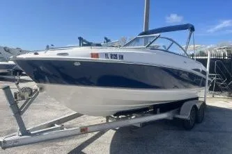 Slide: The Image of 2008 Maxum 2100 SC3 boat on trailer, blue and white, parked outdoors. - 4