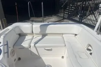 Slide: The Image of 2008 Maxum 2100 SC3 boat interior with white seating and storage compartments. - 11