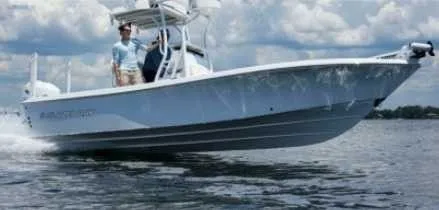 The Image of A Blazer Bay 2440 boat cruising on the water with a person on board. - 0