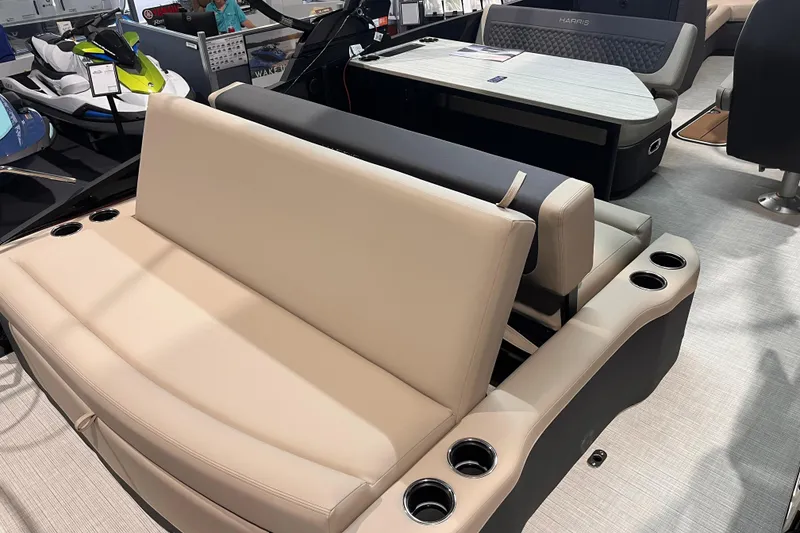 Slide: The Image of 2026 Harris Sunliner 250 boat interior with beige seating and cup holders. - 6