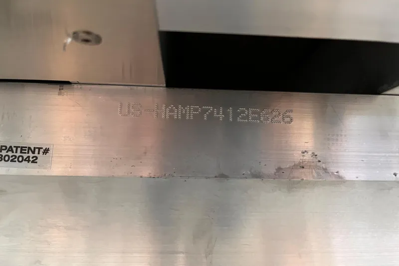 Slide: The Image of Close-up of Harris Sunliner 250 (2026) metal part with patent number and serial code. - 16