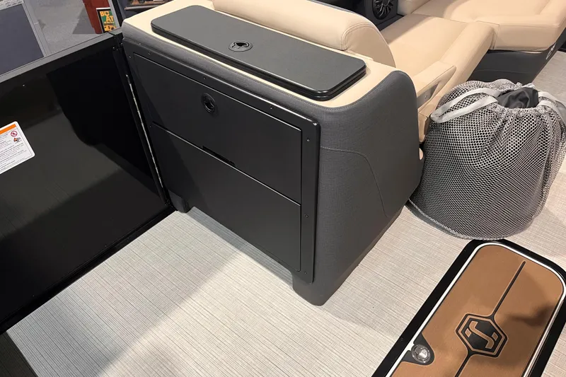 Slide: The Image of 2026 Harris Sunliner 250 interior with seating, storage, and mesh bag on deck. - 10