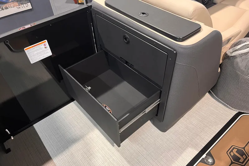 Slide: The Image of Open storage compartment in 2026 Harris Sunliner 250 boat interior. - 11