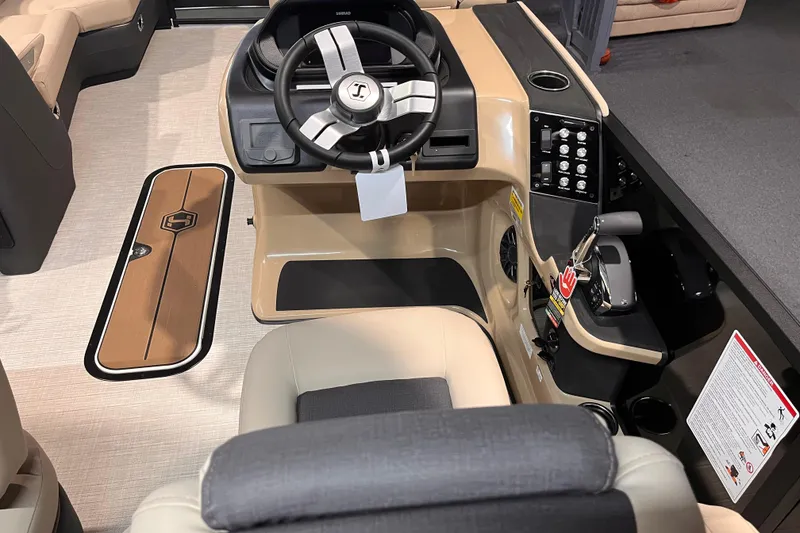 Slide: The Image of Interior view of 2026 Harris Sunliner 250 boat cockpit with steering wheel and controls. - 8