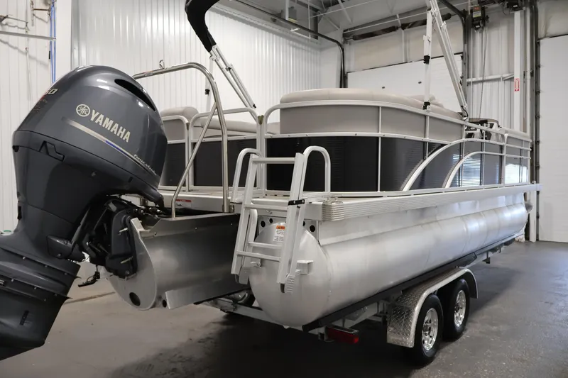 Slide: The Image of 2023 Bennington SV 22 Quad Bench pontoon boat with Yamaha engine in a garage. - 5