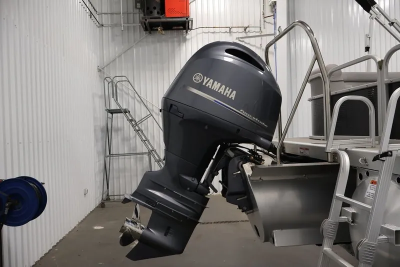 Slide: The Image of 2023 Bennington SV 22 Quad Bench with Yamaha outboard motor in a storage facility. - 31