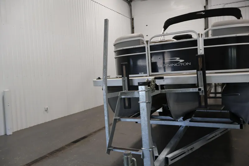 Slide: The Image of 2023 Bennington SV 22 Quad Bench pontoon boat on trailer in storage facility. - 40