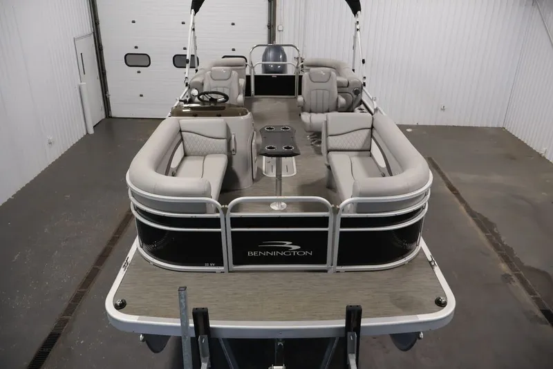 Slide: The Image of 2023 Bennington SV 22 Quad Bench pontoon boat in a showroom setting. - 10