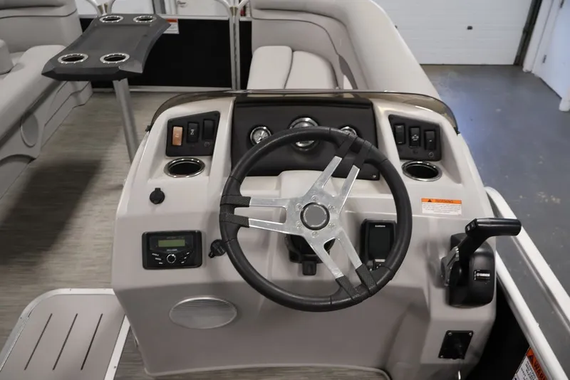 Slide: The Image of 2023 Bennington SV 22 Quad Bench boat dashboard with steering wheel and controls. - 17