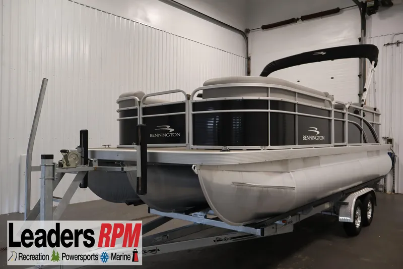 The Image of 2023 Bennington SV 22 Quad Bench pontoon boat on trailer in indoor storage. - 1